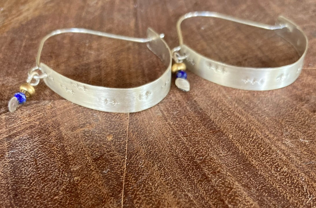 Swinging Sisters, textured sterling silver hoop earrings, featuring lapis lazuli and brass bead detail.