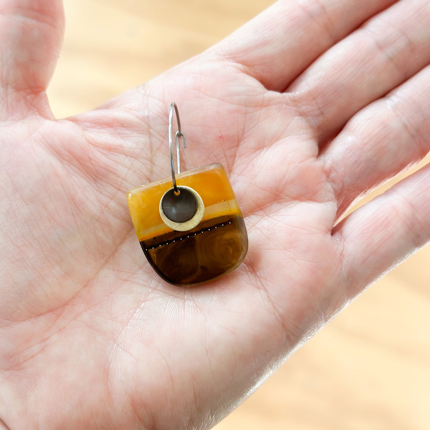 Wild things: umber and amber hoop bio-resin earrings with oxidised brass details