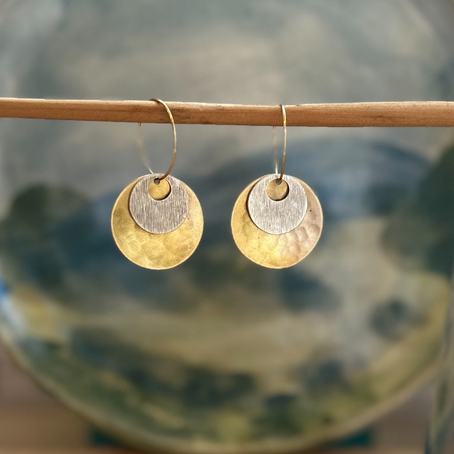 Wanderers: beaten brass discs with silver plated concave disc on gold hoops