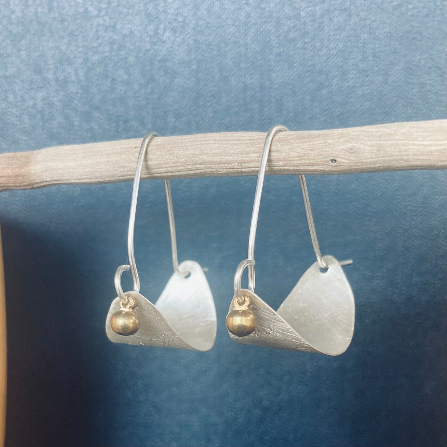 Swinging Sister, sterling silver hoop earrings. Featuring flower petal embossed detail and brass drop.