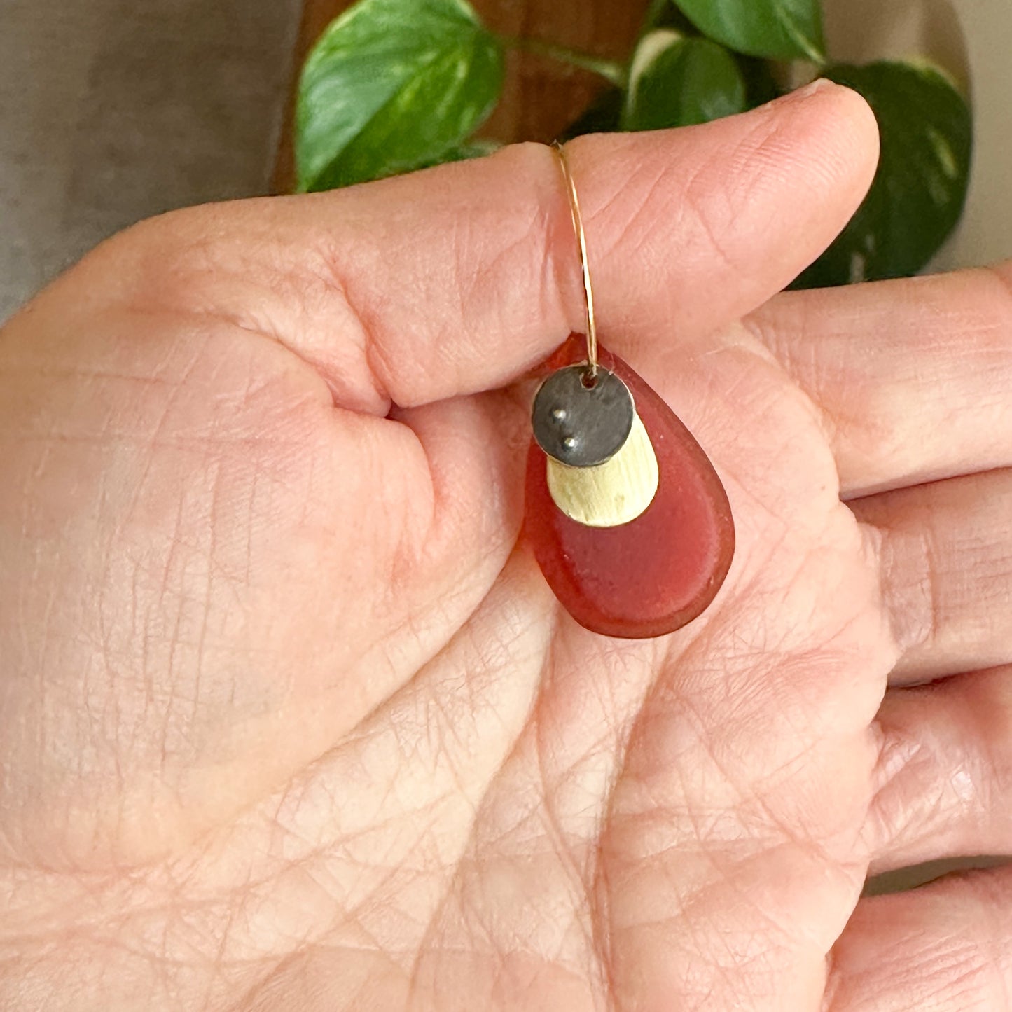 Tear drops: burnt orange tear-drop bio-resin hoops with layered brushed brass and oxidised metal disc