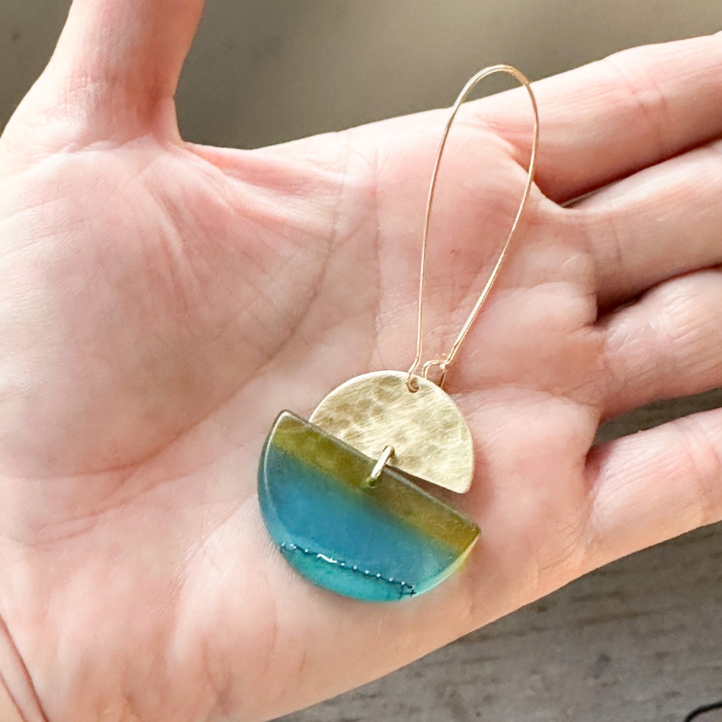 Swinging sisters: long drop turquoise and green bio-resin earrings with beaten brass half moon