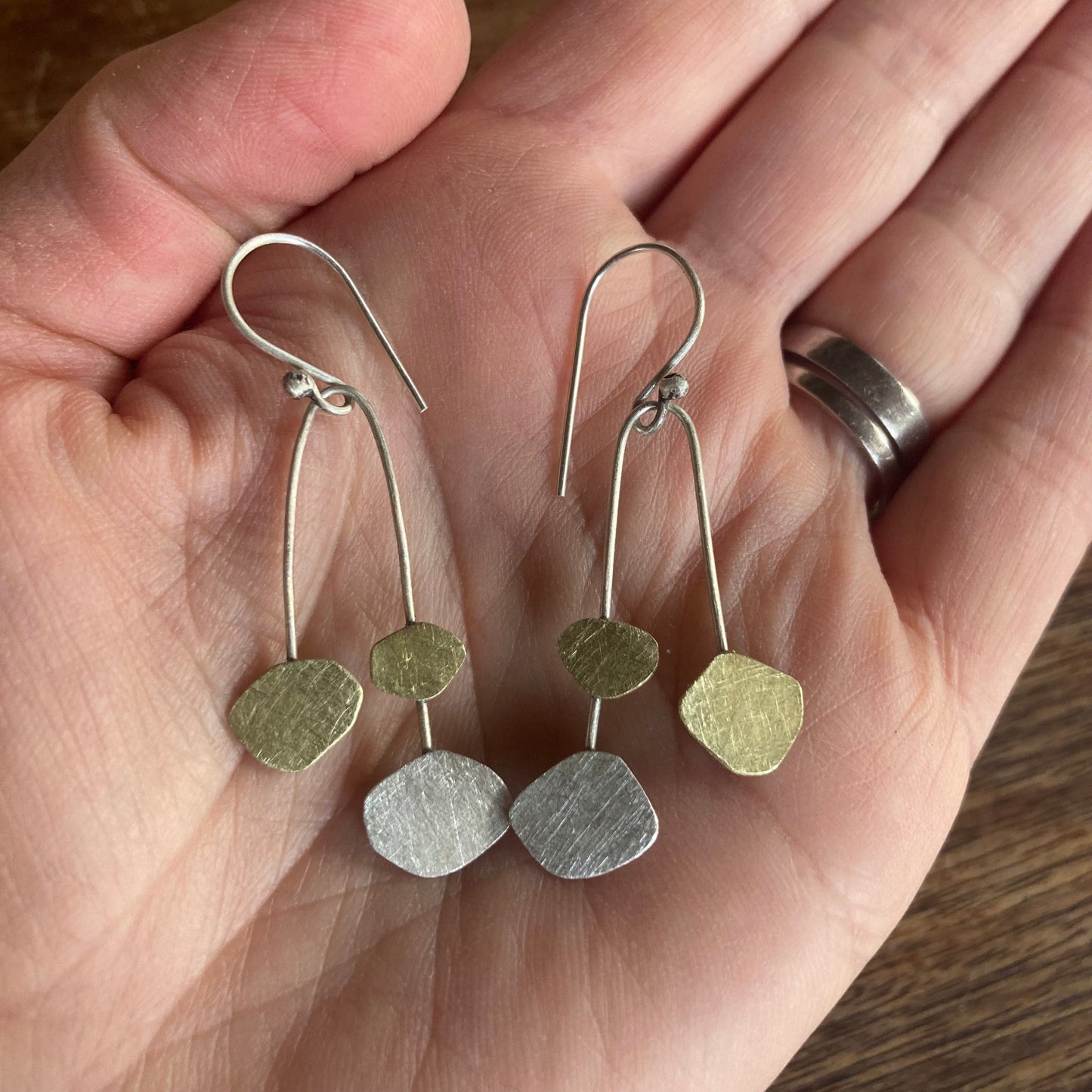 Mobile Cloud earrings. Our homage to Calder, these beauties celebrate whimsy, dancing clouds in Sterling silver and brass. Sterling silver ear hooks.