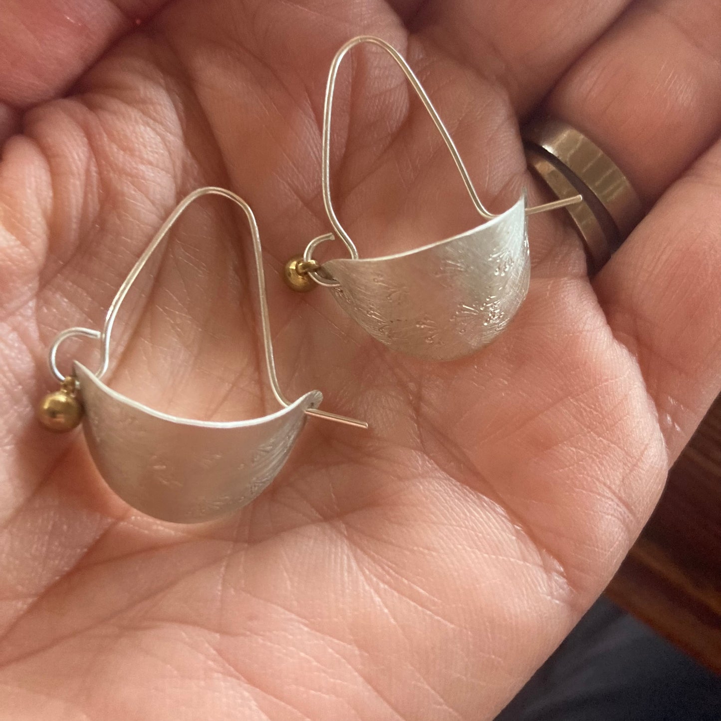 Swinging Sister, sterling silver hoop earrings. Featuring flower petal embossed detail and brass drop.