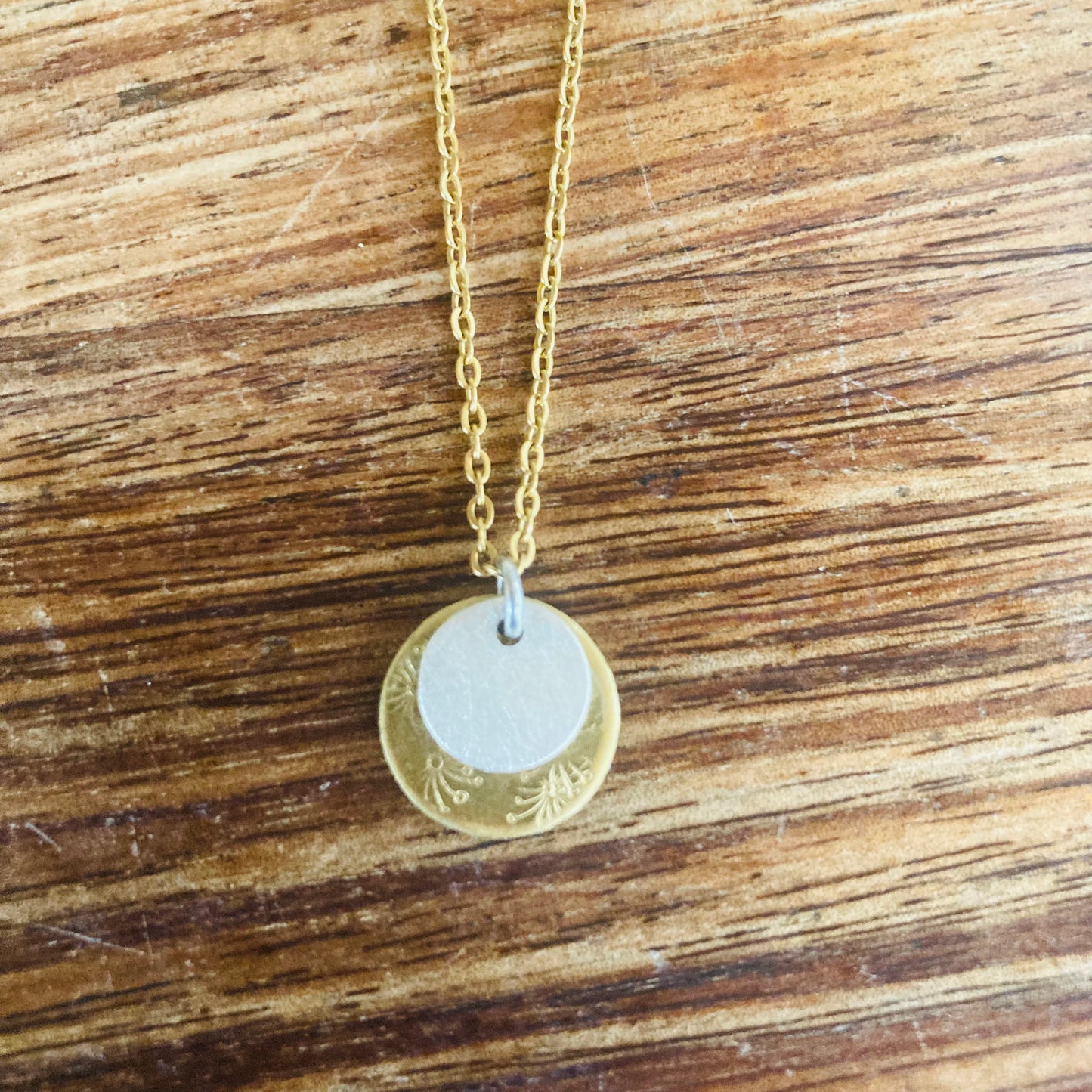 Brass and Sterling silver Pendant. This little beauty features embossed flower motif and sterling silver overlay. A lovely pendant for everyday splendour.