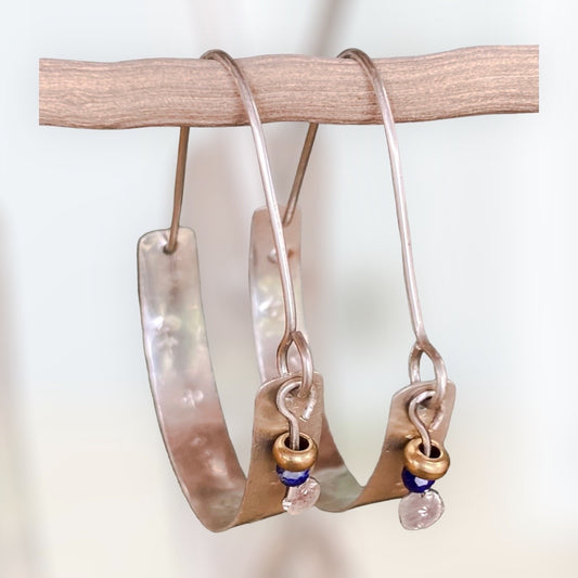 Swinging Sisters, textured sterling silver hoop earrings, featuring lapis lazuli and brass bead detail.