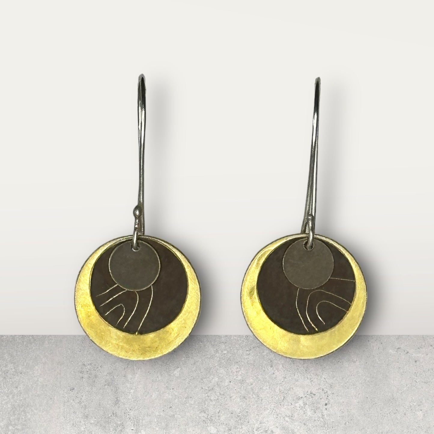 Wanderers: beaten brass discs with hand etched brown patina and oxide metal small disc on sterling silver ear hooks