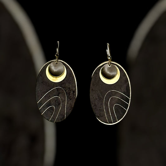 Wanderers: black oxidised metal with etched contours and brass detail