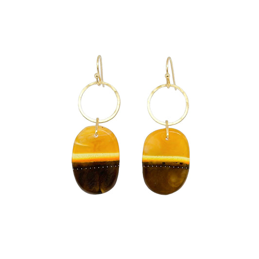 Wild things: deep umber and amber bio-resin with brushed brass circles